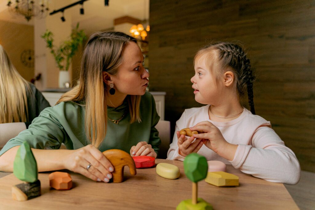 A girl with an intellectual disability works with her teacher in the classroom.